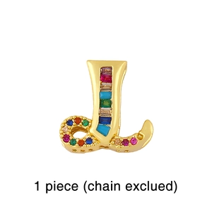 Close-up of golden letter J pendant with rainbow crystals for DIY mesh strap bracelets