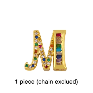 Detailed view of golden letter M charm featuring colorful inlaid zircon gemstones