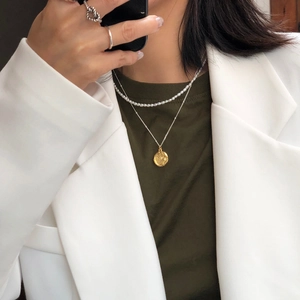 Layered 925 silver freshwater pearl necklace with gold coin pendant on model
