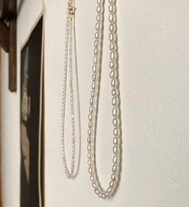 Detail of 925 sterling silver freshwater pearl necklace with gold lobster clasp closure