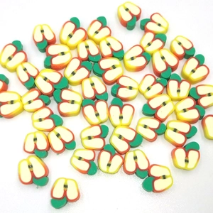 Detailed close-up of handmade 10mm apple-shaped polymer clay beads for DIY jewelry making