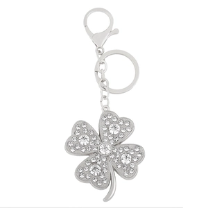 Silver four-leaf clover keychain with sparkling rhinestones and lobster clasp on white background