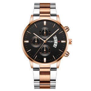 Macro view of two-tone stainless steel watch with chronograph black dial and date window