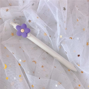 White retractable gel pen with purple flower clip on soft starry mesh background