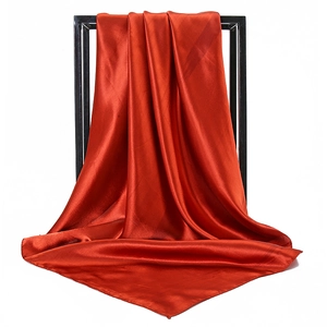 Detailed view of dark red satin silk square scarf draped to show soft texture and high shine