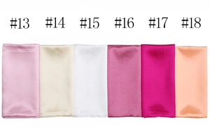 Multiple colors of satin silk square scarves folded neatly in a color selection guide