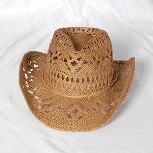 Handwoven hollow-out cowboy straw hat in natural brown with a wide curved brim