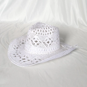 Detail of hand-woven white hollow cowboy straw hat with elegant crochet wave brim design