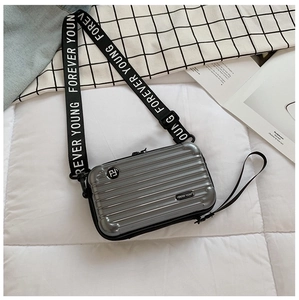 Detail of silver mini suitcase crossbody bag with Forever Young nylon strap and hardshell