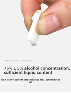 Macro shot of a 75% alcohol wipe being squeezed to show high liquid content and fiber texture