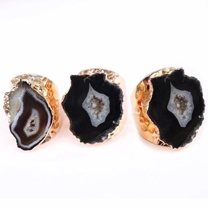 Natural agate geode rings with gold-plated edges and adjustable bands on white background