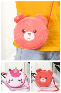 Close-up of plush cartoon unicorn and bear crossbody bags with soft texture details