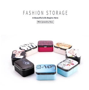 Macro view of portable mini jewelry boxes with various prints and colors for storage