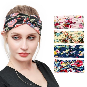 Detail showing five floral print yoga headbands with knot design and elastic knit fabric