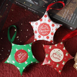 Set of star-shaped Christmas gift boxes in red, green, and white with silk handles