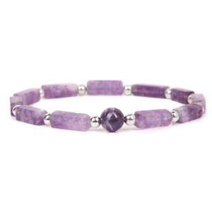Macro shot of natural amethyst rectangular beads and silver spacers on a purple bracelet