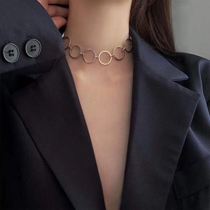 Detail view of interlocking silver circles choker necklace worn by a fashion model