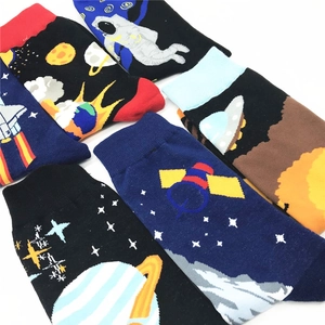 Close-up of crew socks featuring knitted space patterns like astronauts and rockets