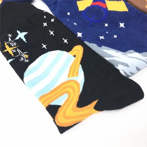 Close-up of galaxy-themed crew socks with embroidered planets and space motifs