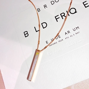 Macro shot of rose gold rectangular pendant featuring iridescent shell inlay details