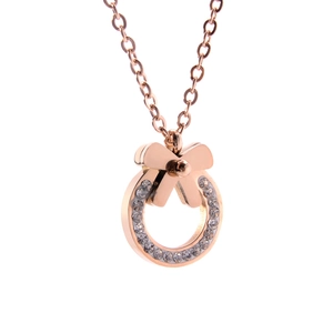 Rose gold bow and circle pendant necklace with sparkling cubic zirconia on white background
