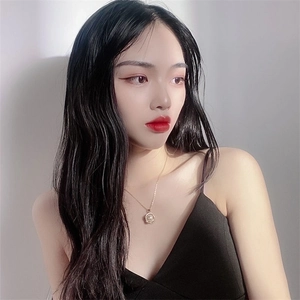 Elegant gold necklace with circular pearl pendant worn by model on a minimalist background