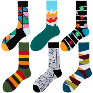 Close-up of six pairs of colorful patterned mid-calf socks with geometric and wave designs