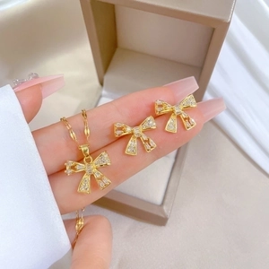 Elegant gold titanium steel bow jewelry set with sparkling rhinestones for women