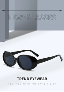 Close-up of retro oval sunglasses with shiny black frames and blue-tinted lenses