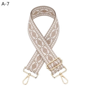 Detail of adjustable geometric diamond pattern bag strap with gold metal lobster hooks
