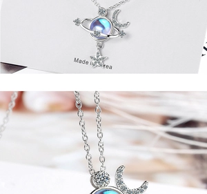 Detailed view of the star and moon pendant with shimmering stones on a silver chain