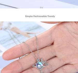 Close-up of star and moon galaxy necklace with blue moonstone and silver finish