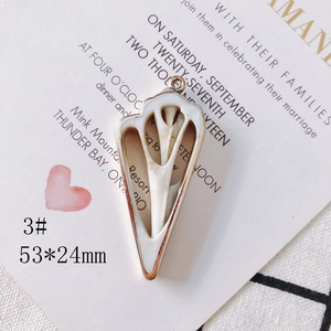 Detail of white triangle shell pendant with gold edges, size 53x24mm for DIY jewelry