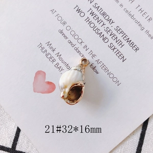 Detailed view of white shell conch pendant with gold plating for DIY jewelry making
