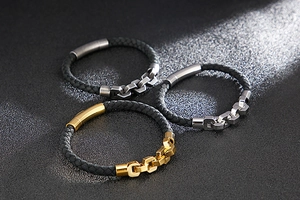 Close-up of leather braided bracelets with metallic chain links and magnetic clasps