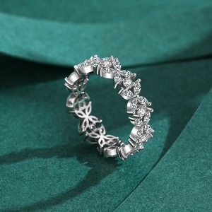 Minimalist silver flower ring with marquise cut gemstones on green fabric background