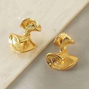 Abstract golden bow earrings with hammer texture and organic design in vintage style