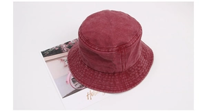 Detail of burgundy washed cotton bucket hat showing vintage fabric texture and stitching