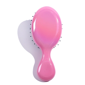 Detailed top view of a pink glossy cartoon hairbrush for kids on a white background