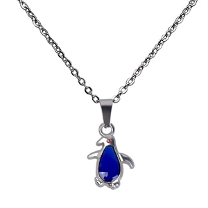 Close-up of color-changing penguin pendant on a stainless steel chain necklace