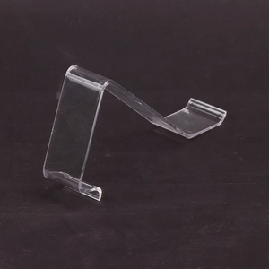 Clear acrylic shoe display stand for retail shop with minimalist geometric curved design