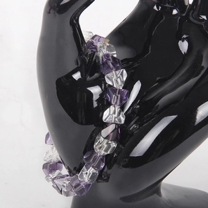 Transparent beaded bracelet with purple H-cut crystal beads on black hand model