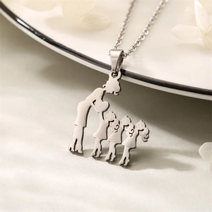 Detailed view of silver necklace pendant featuring a mother and three children silhouette