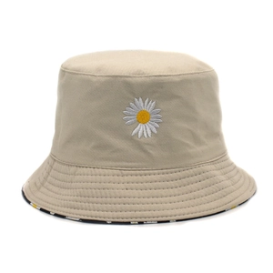 Close-up of daisy embroidery on a beige cotton sun hat with durable stitched brim detail