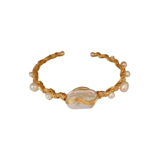 Elegant gold woven open bangle featuring baroque pearls and bohemian handcrafted design