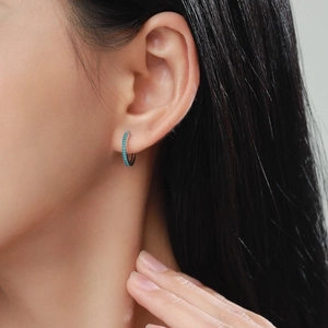 Elegant S925 sterling silver hoop earrings with turquoise stones on a female model