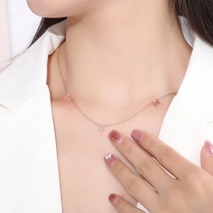 Elegant 18K gold plated stainless steel necklace featuring MOM letter pendants on a model