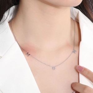 French vintage silver MOM letter necklace for women worn with white blazer