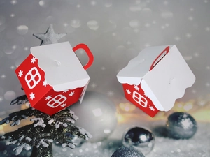 Detail of red Christmas house favor boxes with snowy roof and white window patterns