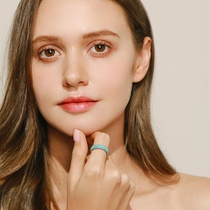 Vintage S925 sterling silver turquoise eternity ring on a model with a minimalist backdrop
